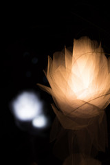 Fabric flowers with light with a bokeh background.