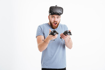 Joyful cheerful man wearing virtual reality device