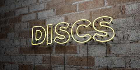 DISCS - Glowing Neon Sign on stonework wall - 3D rendered royalty free stock illustration.  Can be used for online banner ads and direct mailers..