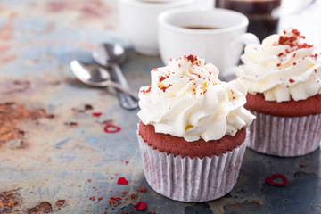 Delicious red velvet cupcakes for Valentines Day on rusty old metal background. Holiday food concept. Copy space.