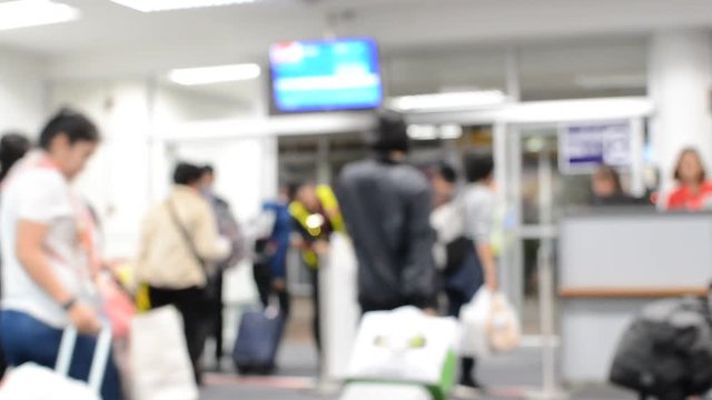 Defocus or Blur of People ( Man, Woman and Child ) on the Line to Departure Boarding to the Airplane. Dark tone.