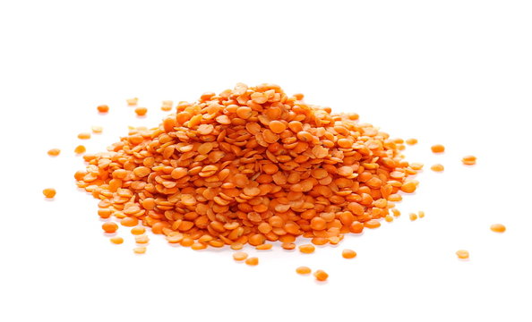 pile red lentils isolated on white background and texture