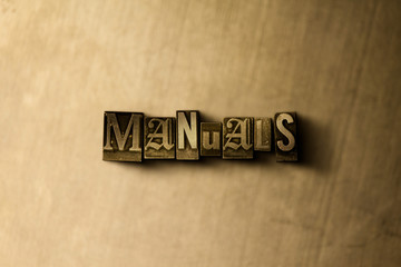 MANUALS - close-up of grungy vintage typeset word on metal backdrop. Royalty free stock - 3D rendered stock image.  Can be used for online banner ads and direct mail.
