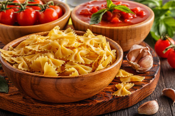 Products for cooking -  pasta, tomatoes, garlic, olive oil.