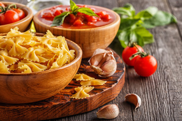 Products for cooking -  pasta, tomatoes, garlic, olive oil.