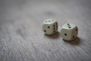 game abstract: two dice number one and number two on a wooden table
