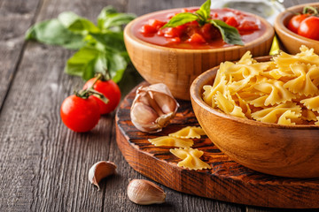Products for cooking -  pasta, tomatoes, garlic, olive oil.