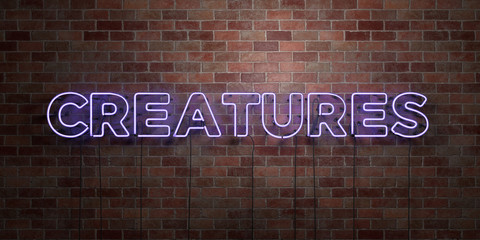 CREATURES - fluorescent Neon tube Sign on brickwork - Front view - 3D rendered royalty free stock picture. Can be used for online banner ads and direct mailers..
