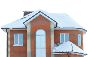 isolated brick apartment house with a snow-covered roof