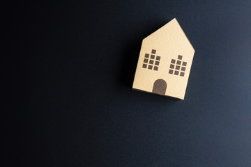 Obraz na płótnie Canvas Home architectural model paper box cubes on black background wit