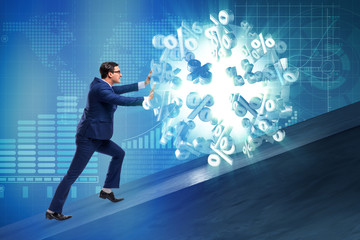 Businessman pushing away high interest rates