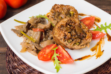 Meatloaf stuffed with mushrooms  sauce and berries. Wooden rustic background. Close-up
