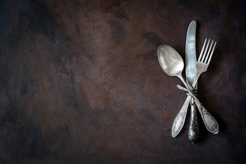 Vintage cutlery / silverware on dark background with copy space for text