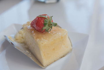 Strawberry cheesecake On a white plate .