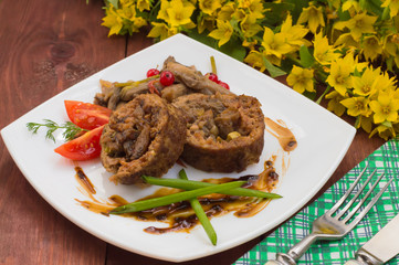 Meatloaf stuffed with mushrooms  sauce and berries. Wooden rustic background. Close-up