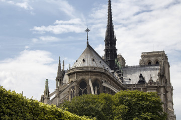 Fototapeta na wymiar Back view of Notre Dame Cathedral in Paris. Towering, 13th-century cathedral with flying buttresses & gargoyles, setting for Hugo's novel.