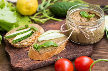 Liver pate with baguette. On a wooden rustic background. Close-up