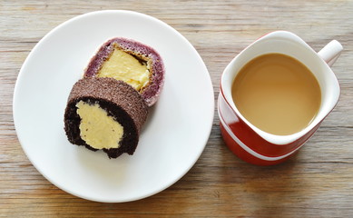 chocolate and grape jam roll filled cream eat couple with coffee in red cup