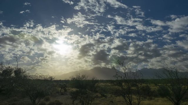 Time lapse of sun rays and mountain peaks
