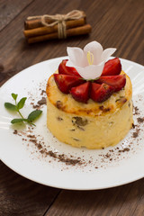 Curd pudding with raisins and strawberry. Wooden rustic table. Close-up. Top view