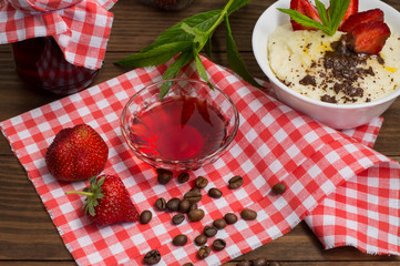 Semolina with grated chocolate and strawberry on a fabulously delicious tomorrow. Wooden background. Top view. Close-up