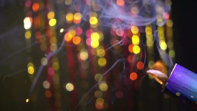 Christmas cracker explodes and confetti flies straight on dark background. Slow motion, 250fps 
