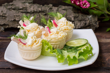 Tartlets with cream cheese  garlic sauce. Wooden background. Close-up
