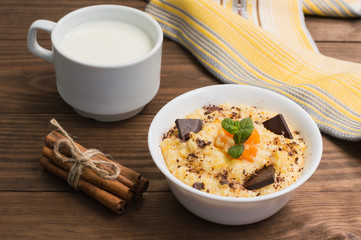 Wheat cereals with pumpkin and chocolate. Wooden rustic background. Close-up. Top view