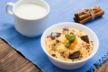 Wheat cereals with pumpkin and chocolate. Wooden rustic background. Close-up. Top view