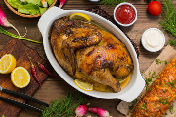 Grilled chicken marinated in balsamic sauce, spicy Italian herbs and fresh lemon. Restaurant supply on a wooden table. Close-up. Top view