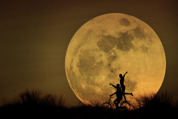 couple biking on moonlight
