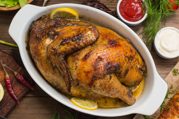 Grilled chicken marinated in balsamic sauce, spicy Italian herbs and fresh lemon. Restaurant supply on a wooden table. Close-up. Top view