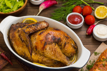 Grilled chicken marinated in balsamic sauce, spicy Italian herbs and fresh lemon. Restaurant supply on a wooden table. Close-up. Top view