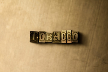 Fototapeta premium TOBACCO - close-up of grungy vintage typeset word on metal backdrop. Royalty free stock - 3D rendered stock image. Can be used for online banner ads and direct mail.