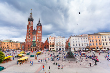 Church of St. Mary in the main Market Square on the background of dramatic sky. Basilica Mariacka....