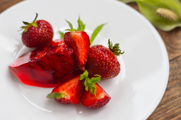 Jelly with strawberries. On a wooden rustic background. Close-up. Top view