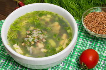 Buckwheat soup on a wooden table. Top view