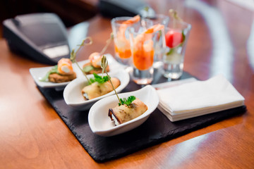 Catering eggplant rolled with cheese and shrimp in wineglass
