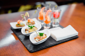 Catering eggplant rolled with cheese and shrimp in wineglass