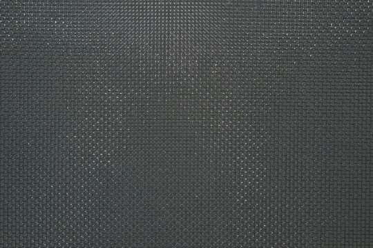 The surface of the metal mesh in grey color with small holes