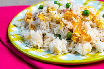 Homemade Chinese fried rice with vegetables and fried eggs