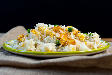 Homemade Chinese fried rice with vegetables and fried eggs