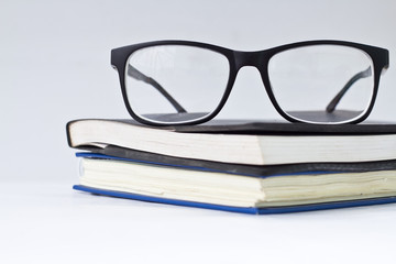 glasses and book isolated on white background.