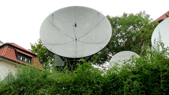 view of the group of satellites on the hedge by the family house in the suburb 