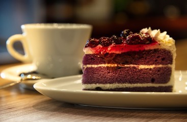 Cup of latte coffee with cake.