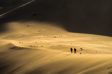 Fototapeta na wymiar Walking a Sand Dune