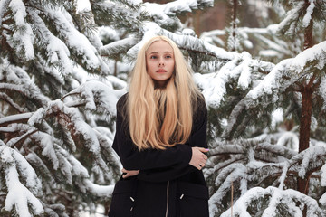 girl in a snowy winter forest. slum