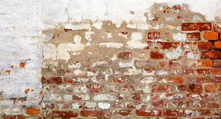 Vintage red brick Wall With Peeled Plaster.