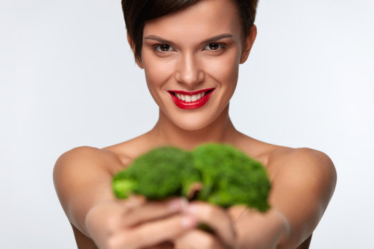 Healthy Foods. Beautiful Woman Holding Organic Green Broccoli