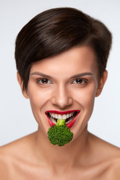 Healthy Woman On Diet. Beautiful Girl Eating Green Broccoli